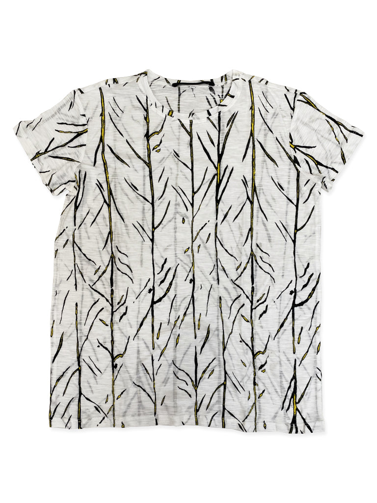 White background with flat lay of white short sleeve tee with branch like patterns in yellow and black all over