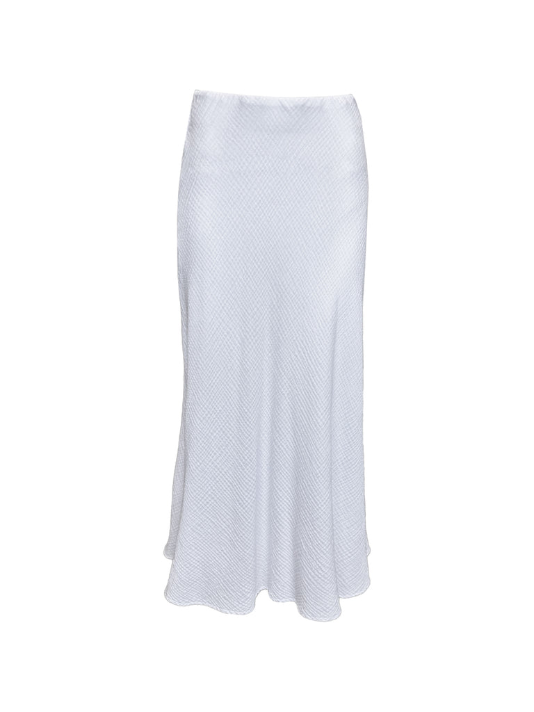 An image of the Joanie’s skirt against a white background. The skirt is a maxi slip style slip-on skirt in white with a soft bubbled / raised texture. 