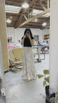A video of a woman wearing the Maxi Wrap Skirt in Summer Floral flowing in the wind